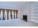 Carpeted living room featuring a fireplace, built-in shelves and sliding glass doors to a balcony at 13635 Twin Lakes Ln # 13635, Tampa, FL 33618