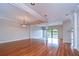 Spacious living room with hardwood floors, elegant columns, and sliding glass doors to outdoor living space at 13635 Twin Lakes Ln # 13635, Tampa, FL 33618