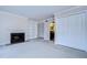 Living room with fireplace and built in shelves looks towards hallway entrance and a closet at 13635 Twin Lakes Ln # 13635, Tampa, FL 33618