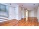View of the living room highlighting the beautiful hardwood flooring and staircase at 13635 Twin Lakes Ln # 13635, Tampa, FL 33618