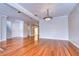 Spacious living room featuring hardwood floors, a modern lighting fixture, and neutral wall tones at 13635 Twin Lakes Ln # 13635, Tampa, FL 33618