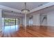 Bright living room with hardwood floors and columns, with sliding glass doors leading to the outside deck at 13635 Twin Lakes Ln # 13635, Tampa, FL 33618
