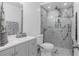 Beautifully remodeled bathroom with a glass-enclosed shower, modern vanity, and marble accents at 1406 Valley Pl, Brandon, FL 33510