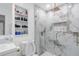 Chic bathroom features a large shower with a glass door, a toilet, and shelving at 1406 Valley Pl, Brandon, FL 33510