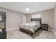 Well-lit bedroom features a bed with a decorative headboard, a window, and a nightstand at 1406 Valley Pl, Brandon, FL 33510