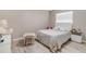 Bright bedroom with a queen bed, side table, table and chair, and a large stuffed bear at 1406 Valley Pl, Brandon, FL 33510