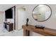 Stylish entryway featuring a modern console table, round mirror, and elegant marble flooring at 1406 Valley Pl, Brandon, FL 33510