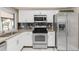 Well-lit kitchen with white cabinetry, stainless steel appliances, window, and granite countertops at 1406 Valley Pl, Brandon, FL 33510