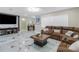 Open-concept living room featuring plush seating, modern decor, and stylish marble flooring at 1406 Valley Pl, Brandon, FL 33510