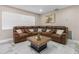 Spacious living room features a large leather couch, marble floors, and a decorative coffee table at 1406 Valley Pl, Brandon, FL 33510