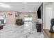 Bright and airy living room with marble floors, sleek furniture, and a sliding glass door at 1406 Valley Pl, Brandon, FL 33510