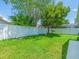 Spacious backyard featuring a well-maintained lawn and white vinyl fence at 14103 Stonebrook Ct, Tampa, FL 33624