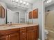 Bathroom featuring double sink vanity with cabinets, and a shower and tub combo with neutral wall color at 14103 Stonebrook Ct, Tampa, FL 33624