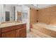 Bathroom features a mosaic tile surround around the bath and vanity at 14103 Stonebrook Ct, Tampa, FL 33624