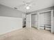 Bedroom featuring wainscoting, a ceiling fan, a closet, and neutral colored carpet flooring at 14103 Stonebrook Ct, Tampa, FL 33624