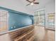 Bedroom features hardwood floors, neutral paint, and a window overlooking the pool at 14103 Stonebrook Ct, Tampa, FL 33624
