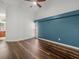 Bedroom features hardwood floors and a pop of color on an accent wall at 14103 Stonebrook Ct, Tampa, FL 33624