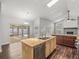 Open-concept kitchen boasting an island sink, granite countertops, and access to the backyard pool area at 14103 Stonebrook Ct, Tampa, FL 33624