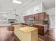 Bright kitchen area with granite countertops, dark wood cabinets, and modern stainless steel appliances at 14103 Stonebrook Ct, Tampa, FL 33624