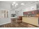 Bright kitchen area with granite countertops, dark wood cabinets, and modern stainless steel appliances at 14103 Stonebrook Ct, Tampa, FL 33624