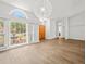 Bright living room with hardwood floors, picture window, and modern light fixture at 14103 Stonebrook Ct, Tampa, FL 33624