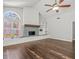 Bright living room features a fireplace, built-in shelving, hardwood floors, and a ceiling fan at 14103 Stonebrook Ct, Tampa, FL 33624