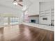 Bright living room with a fireplace, vaulted ceilings, and sliding glass doors to a pool at 14103 Stonebrook Ct, Tampa, FL 33624
