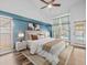 Well-lit main bedroom featuring a king-size bed, matching nightstands, and access to the pool area at 14103 Stonebrook Ct, Tampa, FL 33624