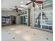 Bright sunroom with neutral colors, ceiling fans, and multiple windows overlooking the pool at 14103 Stonebrook Ct, Tampa, FL 33624