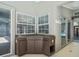 Wet bar featuring dark cabinets and countertop located in the sunroom at 14103 Stonebrook Ct, Tampa, FL 33624