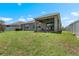 Expansive backyard with green grass, a covered patio, privacy fencing, and serene outdoor space at 1517 Yale Castle Ct, Ruskin, FL 33570