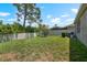 Large backyard with a well-maintained lawn, mature trees, a privacy fence, and an irrigation system at 1517 Yale Castle Ct, Ruskin, FL 33570