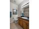 Well-lit bathroom featuring a vanity with wood cabinets, granite countertop, and ceramic tile flooring at 1517 Yale Castle Ct, Ruskin, FL 33570