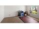 Bright bedroom with a large window, neutral carpeting, and ample space for versatile use at 1517 Yale Castle Ct, Ruskin, FL 33570