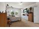 Bright bedroom features soft carpet, large windows overlooking mature landscaping, and standard bedroom furniture at 1517 Yale Castle Ct, Ruskin, FL 33570