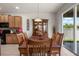 The dining room has a wooden table and matching hutch and is connected to the kitchen at 1517 Yale Castle Ct, Ruskin, FL 33570