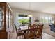 A cozy dining room is enhanced by a wooden table set and views of the backyard through sliding glass doors at 1517 Yale Castle Ct, Ruskin, FL 33570
