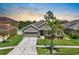 Charming home featuring a well-maintained lawn, landscaping, a two-car garage, and a driveway at 1517 Yale Castle Ct, Ruskin, FL 33570