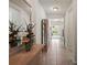 Welcoming hallway featuring tile flooring, a decorative mirror, and views into other rooms at 1517 Yale Castle Ct, Ruskin, FL 33570