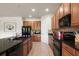 A kitchen featuring tile flooring, wood cabinetry, and a black appliance suite at 1517 Yale Castle Ct, Ruskin, FL 33570