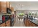 The kitchen has a large island and a view of the dining area and outdoor scenery at 1517 Yale Castle Ct, Ruskin, FL 33570