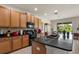Open kitchen with a large island, wood cabinetry, and tile flooring at 1517 Yale Castle Ct, Ruskin, FL 33570