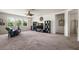 A sprawling living room features comfortable seating, modern entertainment center, and natural light from large windows at 1517 Yale Castle Ct, Ruskin, FL 33570