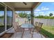 Charming covered patio with a dining table and chairs, perfect for outdoor relaxation and entertaining at 1517 Yale Castle Ct, Ruskin, FL 33570