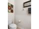 Clean powder room featuring a toilet, artwork, decorative accents, and neutral-toned walls at 1517 Yale Castle Ct, Ruskin, FL 33570