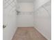 Empty walk-in closet with shelving is ready for customization and organization, providing ample storage space at 1517 Yale Castle Ct, Ruskin, FL 33570