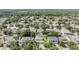 Expansive aerial view showcasing a quiet residential neighborhood with mature trees and well-maintained homes at 1524 Rhodeswell Ln, Dover, FL 33527