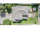 Aerial shot of house showing the roof, driveway, and backyard with patio and gazebo at 1524 Rhodeswell Ln, Dover, FL 33527