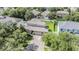 Aerial view of a home featuring mature landscaping, a fenced yard, and a backyard patio at 1524 Rhodeswell Ln, Dover, FL 33527