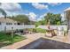 Backyard with an outdoor kitchen, fire pit with chairs, grass, and privacy fence at 1524 Rhodeswell Ln, Dover, FL 33527
